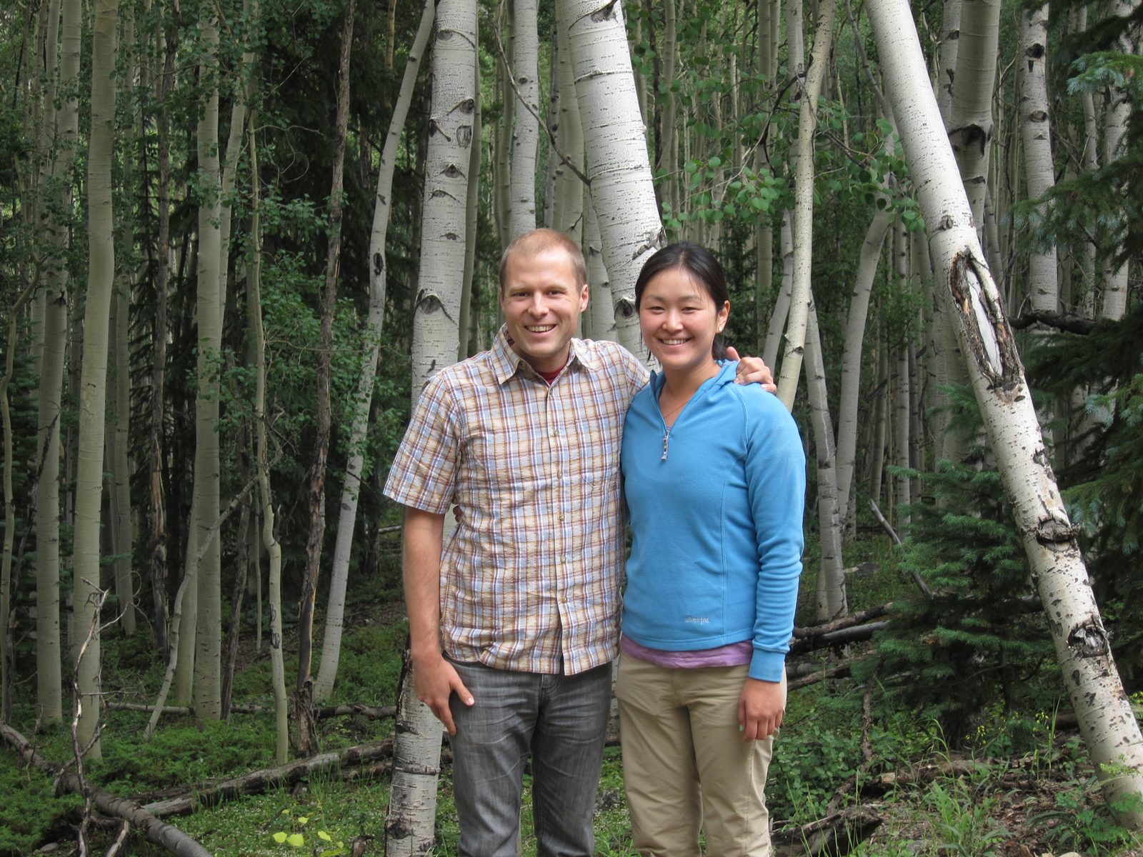 Two folks frolicking among the aspens. 